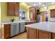 Open kitchen with marble countertops, stainless steel appliances, and custom cabinets at 5895 W 265 N, Columbus, IN 47201