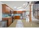 Bright kitchen featuring stainless steel appliances, wooden cabinets, and a vaulted ceiling with a skylight at 5895 W 265 N, Columbus, IN 47201