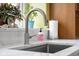 Close up of the kitchen sink with stainless steel faucet, marble countertops, and a large window at 5895 W 265 N, Columbus, IN 47201