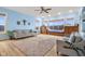 Spacious living room featuring built-in window seat, lots of windows, hardwood floors, and a large area rug at 5895 W 265 N, Columbus, IN 47201