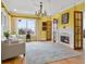 Bright living room with a cozy fireplace, hardwood floors, and ample natural light at 5895 W 265 N, Columbus, IN 47201