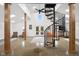 Open concept living room featuring a spiral staircase, concrete floors, natural wood columns, and natural lighting at 5895 W 265 N, Columbus, IN 47201