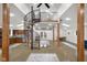 Large open concept living room with concrete floors, spiral staircase, dining table, and a kitchen at 5895 W 265 N, Columbus, IN 47201