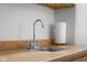 A stainless steel sink is set in a light brown countertop, accented by a classic chrome faucet and paper towel holder at 5895 W 265 N, Columbus, IN 47201