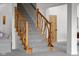 Staircase featuring natural wood railing, and plush grey carpeting at 5895 W 265 N, Columbus, IN 47201
