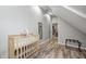 Finished attic space with laminate flooring, gray walls, and a baby crib at 602 E Beecher St, Indianapolis, IN 46203