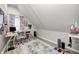 Finished attic space with laminate flooring, a desk, and a window at 602 E Beecher St, Indianapolis, IN 46203