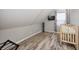 Finished attic space with laminate flooring and a baby crib at 602 E Beecher St, Indianapolis, IN 46203