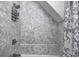 Bathroom shower and tub with gray and white decorative tiling at 602 E Beecher St, Indianapolis, IN 46203