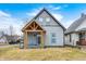 Charming renovated two-story home with a covered front porch and gray siding at 602 E Beecher St, Indianapolis, IN 46203