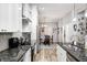 Bright kitchen featuring granite countertops, stainless appliances, and wood flooring at 602 E Beecher St, Indianapolis, IN 46203