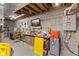 Unfinished basement featuring concrete walls and floors, exposed ceiling, and a workbench with tools at 6428 Bluff Crest Ct, Indianapolis, IN 46217