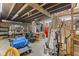 Unfinished basement with exposed wooden beams, and a table covered with miscellaneous items at 6428 Bluff Crest Ct, Indianapolis, IN 46217