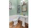 Charming bathroom featuring a pedestal sink and a classic wood-framed mirror at 6428 Bluff Crest Ct, Indianapolis, IN 46217