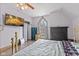 Bedroom featuring a gold metal bed frame, a gothic arched window, and a fireplace at 6428 Bluff Crest Ct, Indianapolis, IN 46217