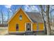 Close up exterior view of a yellow house with a covered porch and dry grassy lot at 6428 Bluff Crest Ct, Indianapolis, IN 46217