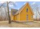 Charming yellow two-story home featuring unique architectural details and a well-maintained front yard at 6428 Bluff Crest Ct, Indianapolis, IN 46217
