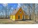 Exterior view of a yellow two-story house with distinctive gothic trim and a dry grassy lot at 6428 Bluff Crest Ct, Indianapolis, IN 46217