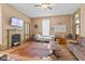 Spacious living room featuring hard wood floors, a fireplace, and lots of natural light at 6428 Bluff Crest Ct, Indianapolis, IN 46217