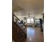Cozy living area with a fireplace, hardwood floors, a ceiling fan, and natural light from the windows at 6817 Everbloom Ln, Indianapolis, IN 46217
