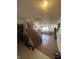 Carpeted staircase with wooden railings, leading to the upper level of the home and the living area at 6817 Everbloom Ln, Indianapolis, IN 46217