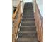 Carpeted staircase with wooden railings, leading to the upper level of the home at 6817 Everbloom Ln, Indianapolis, IN 46217