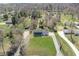 Aerial shot of a home with a big yard and long driveway in a neighborhood with mature trees at 7089 W 150 N, Greenfield, IN 46140