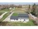 Aerial view of a two-story home with gray siding, a white brick facade, and a long driveway at 7089 W 150 N, Greenfield, IN 46140