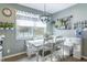 Charming dining area features a large window with winter views and decorative hanging chandelier at 7089 W 150 N, Greenfield, IN 46140