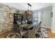 Stylish dining room features a stone accent wall and rustic dining set at 7089 W 150 N, Greenfield, IN 46140