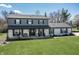 Charming two-story home featuring a front porch, gray siding, a white brick facade, and a lush green lawn at 7089 W 150 N, Greenfield, IN 46140