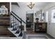 Welcoming foyer with a staircase and decorative cabinet at 7089 W 150 N, Greenfield, IN 46140