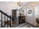 Inviting foyer featuring a view into the dining area, a decorative cabinet, and a patterned rug at 7089 W 150 N, Greenfield, IN 46140