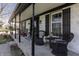 Close up view of the home's inviting front porch with seating and decorative potted plants at 7089 W 150 N, Greenfield, IN 46140