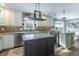 Well lit kitchen with stainless steel appliances, large island, and stone countertops at 7089 W 150 N, Greenfield, IN 46140
