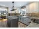 Modern kitchen with stainless steel appliances, island, and brick backsplash at 7089 W 150 N, Greenfield, IN 46140
