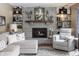 Comfortable living room featuring a brick fireplace, neutral-toned seating, and decorative shelving at 7089 W 150 N, Greenfield, IN 46140