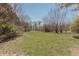 View of the home's spacious lot with mature trees and a lush green lawn at 7089 W 150 N, Greenfield, IN 46140