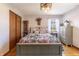 Bright bedroom featuring wood-look walls, a decorative ceiling fan, and well-lit windows at 7089 W 150 N, Greenfield, IN 46140