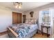 Bedroom with wood-look walls, hardwood floors, and a charming ceiling fan light at 7089 W 150 N, Greenfield, IN 46140