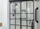 Glass enclosed shower with white subway tile and black accents at 7089 W 150 N, Greenfield, IN 46140