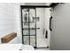Glass enclosed shower with white subway tile and black accents at 7089 W 150 N, Greenfield, IN 46140