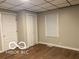 An empty bedroom featuring light-colored walls, wood-look flooring, a window, and two closets at 1220 E Second St, Greenfield, IN 46140