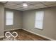 Neutral bedroom featuring wood floors, neutral walls, and two bright windows at 1220 E Second St, Greenfield, IN 46140