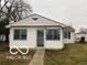 Charming single-story home features a tidy front yard and white siding at 1220 E Second St, Greenfield, IN 46140