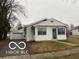 Cozy single-story home with tidy lawn, white siding and detached garage at 1220 E Second St, Greenfield, IN 46140