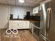 Modern kitchen boasts stainless steel appliances, sleek countertops, and ample cabinetry at 1220 E Second St, Greenfield, IN 46140