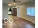 Open-concept living room with wood floors that opens to kitchen with stainless appliances at 1220 E Second St, Greenfield, IN 46140