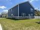 A view of a two story home featuring blue siding, a well kept lawn and sliding back door at 1256 Turner Trace N Pl, Avon, IN 46123