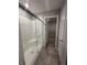 Bathroom featuring glass door shower with a gray tiled floor and view to walk-in closet at 1256 Turner Trace N Pl, Avon, IN 46123